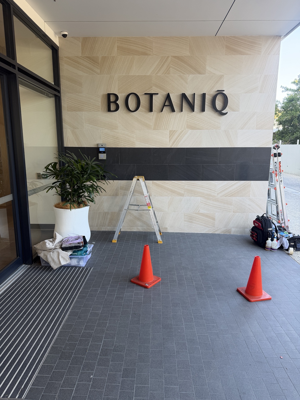 Wall lettering during installation at a building entrance